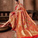 Woman wearing a red Banarasi silk saree with golden zari work